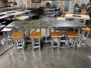 Panoramic view of long worktable with stools