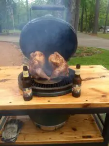 Chicken is being grilled on one of the tables
