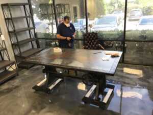 The man is working on a customized desk unit