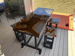 Top view of distressed metal worktable with stools