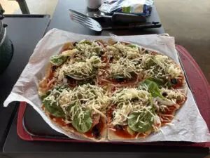 A completed pizza with cheese and other toppings