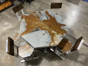 Another distressed metal worktable with stools