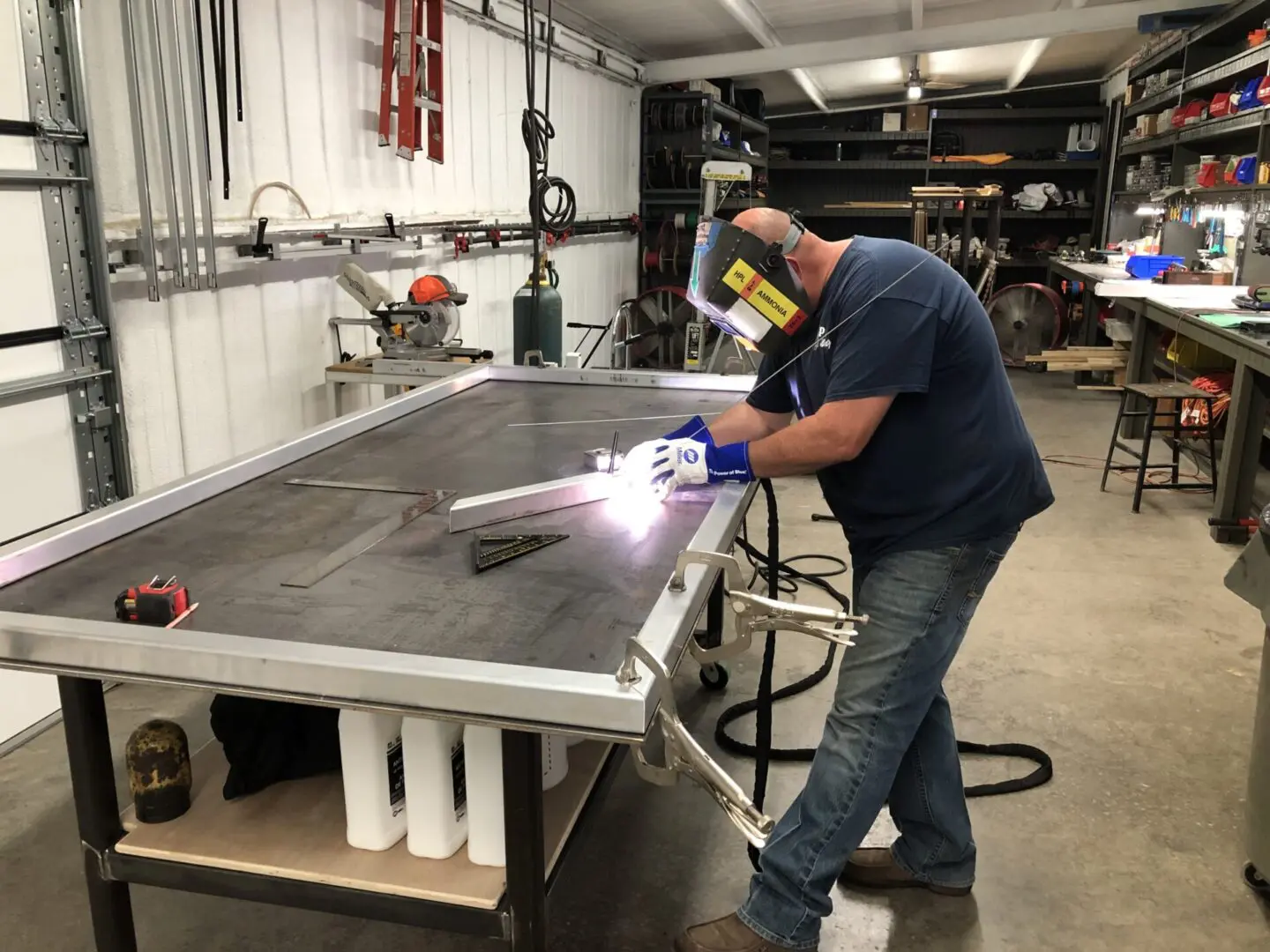 Welding work in progress during table construction